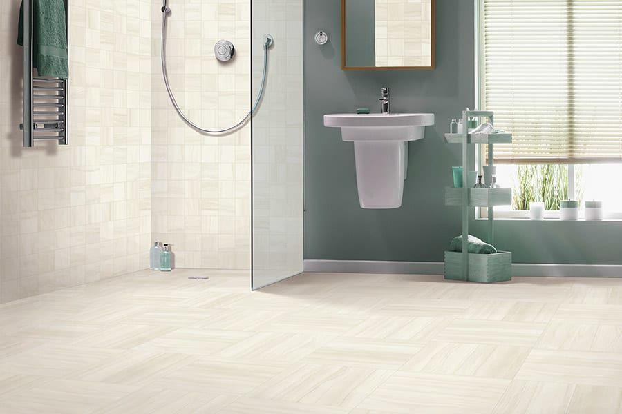 A bathroom with a sink and a walk in shower.