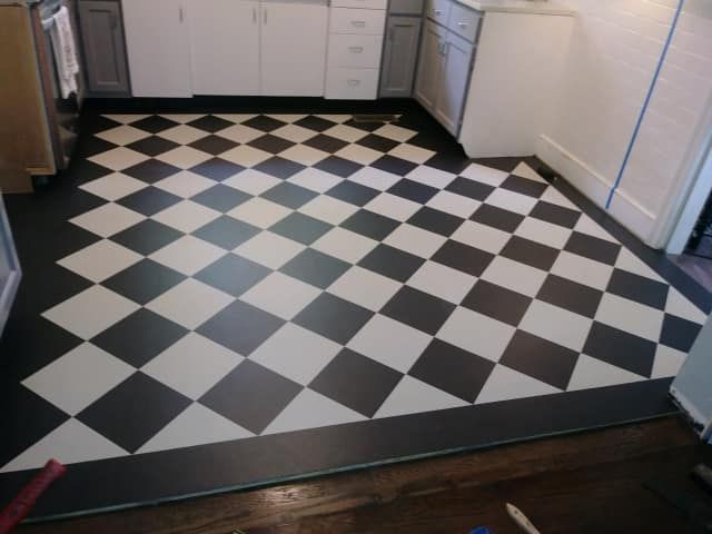 A black and white checkered floor in a kitchen