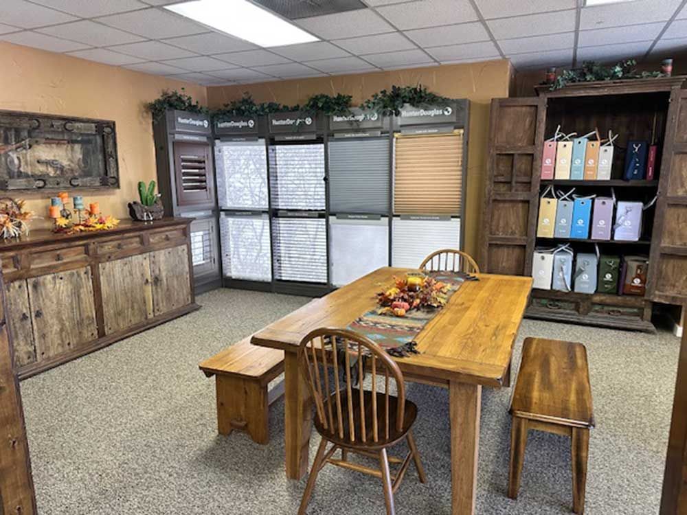 A dining room with a wooden table and chairs and a bench.