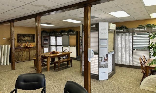 A large room with a table and chairs in it