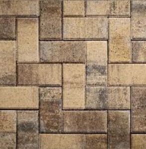 Close-up of interlocking brick pavers in shades of tan and brown, laid in a staggered pattern.
