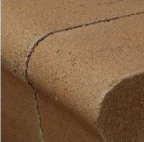 Close-up of brown textured material with curved edges and a seam.