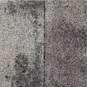 Two gray carpet tiles, left tile lighter than right, with a dark seam.