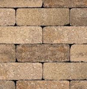Close-up of a brick wall pattern with rectangular tan and brown bricks arranged in a running bond pattern.