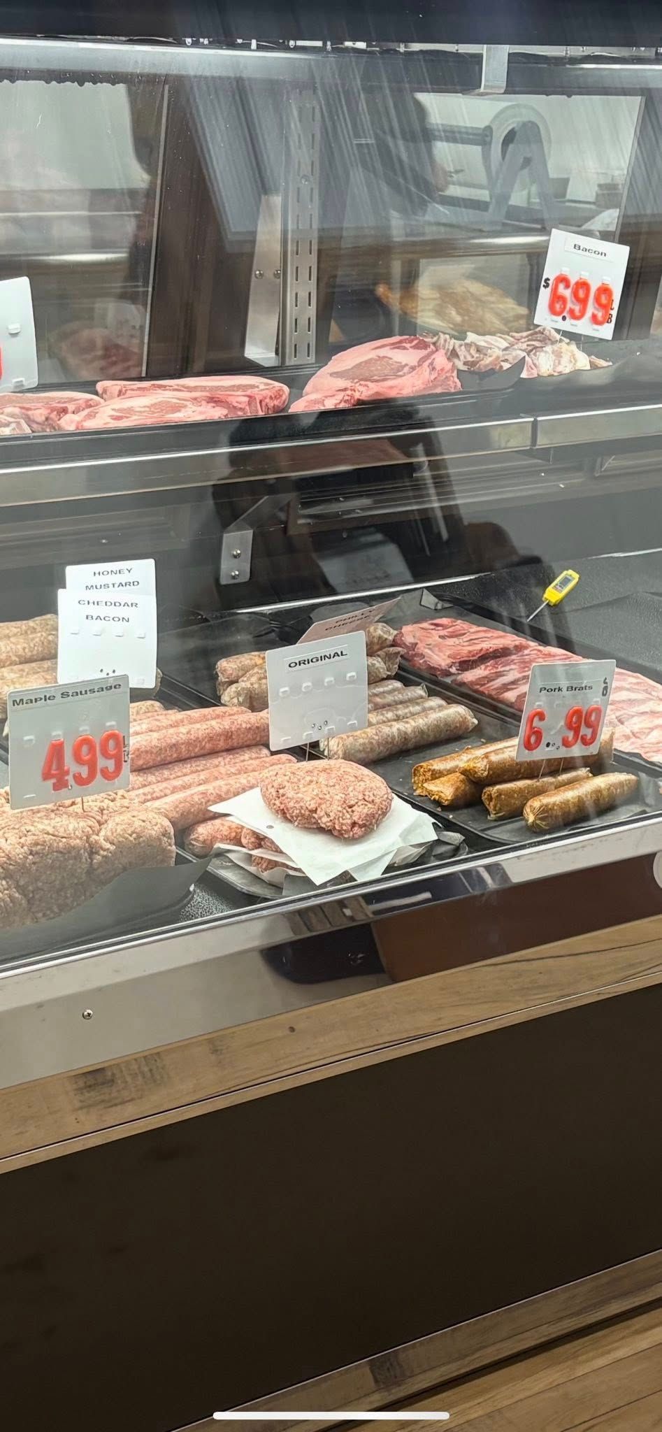 Meat display case with price tags.