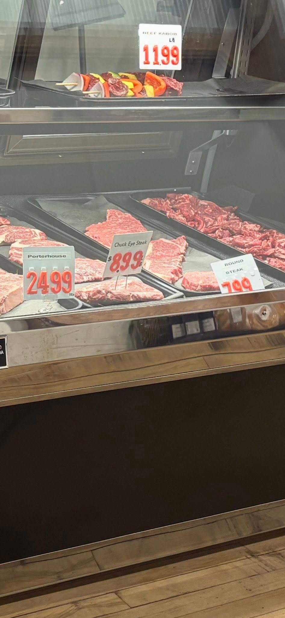Meat display case with price tags.