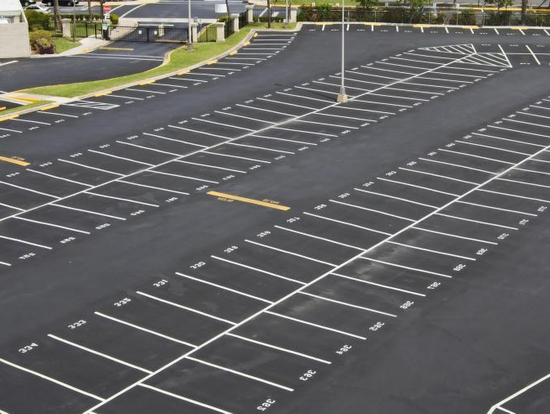 An aerial view of a parking lot with white lines