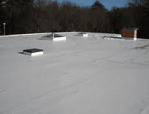 A white roof with a chimney and skylights on it