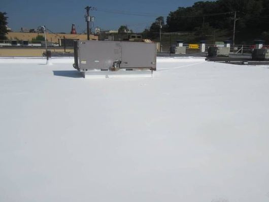 A white roof with a gray box on top of it.