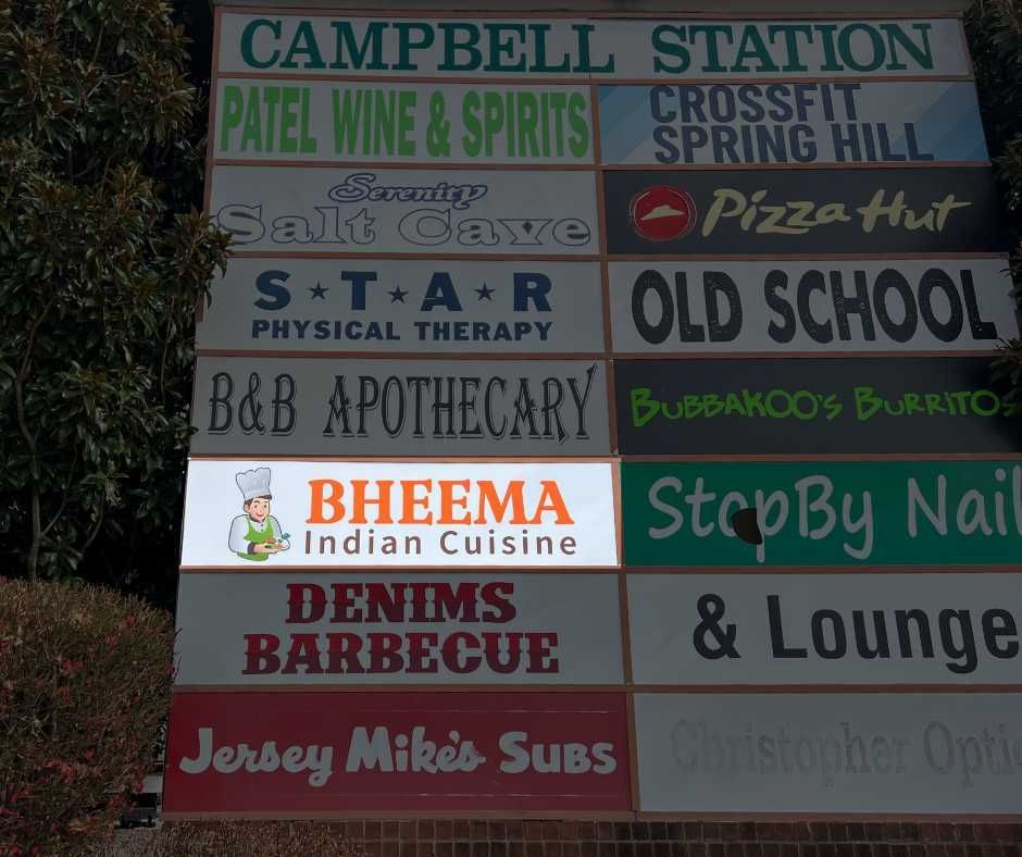 A directory sign for Campbell Station businesses, listing names like Bheema Indian Cuisine, Pizza Hut, and Jersey Mike's