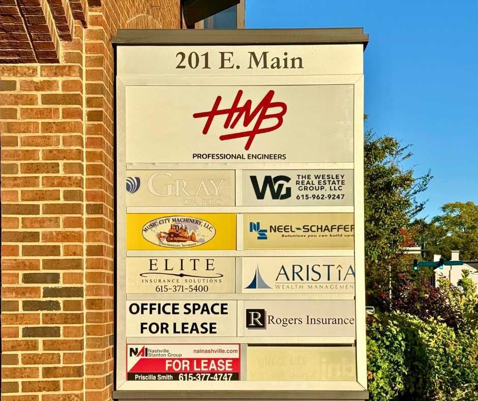 A directory sign for the building at 201 E. Main, listing various professional businesses and office spaces for lease