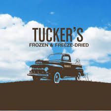 A black truck is parked on top of a dirt hill.