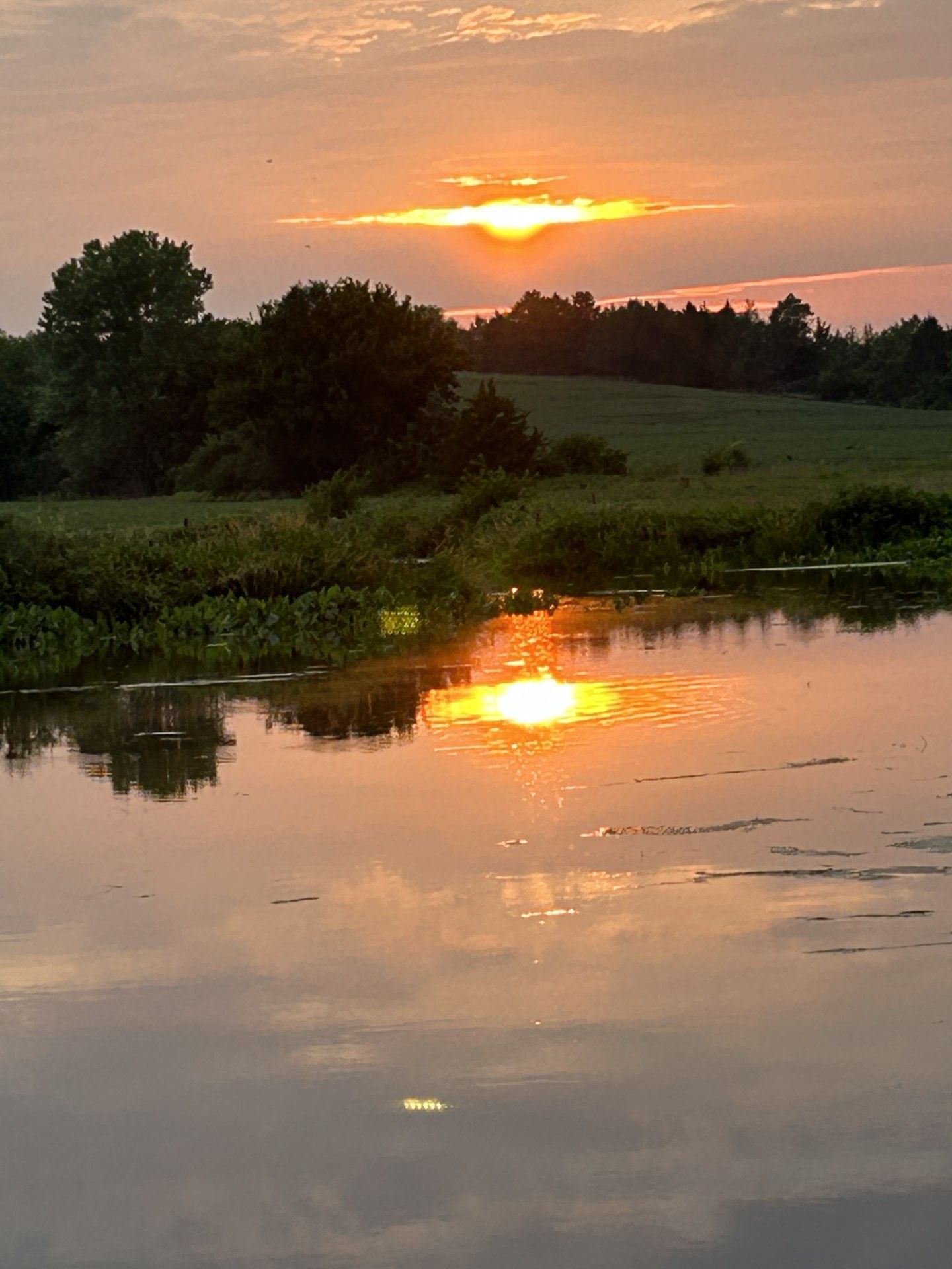 The sun is setting over a body of water.