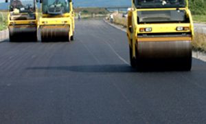 Three road rollers on the fresh tar road