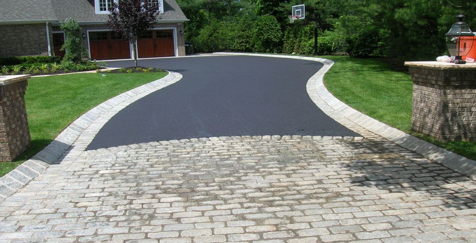 A home with a driveway of asphalt and pavers