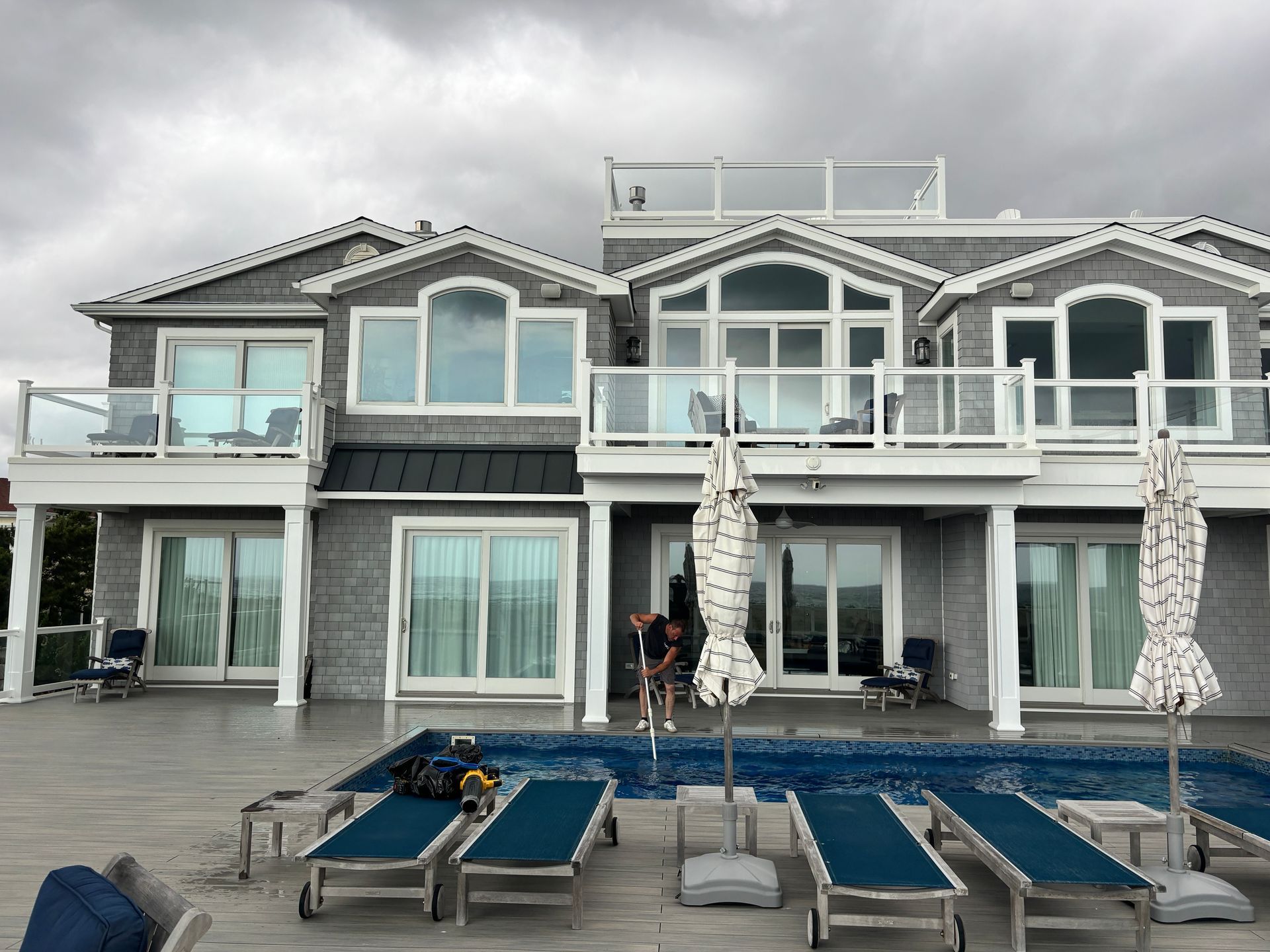 A large house with a swimming pool in front of it