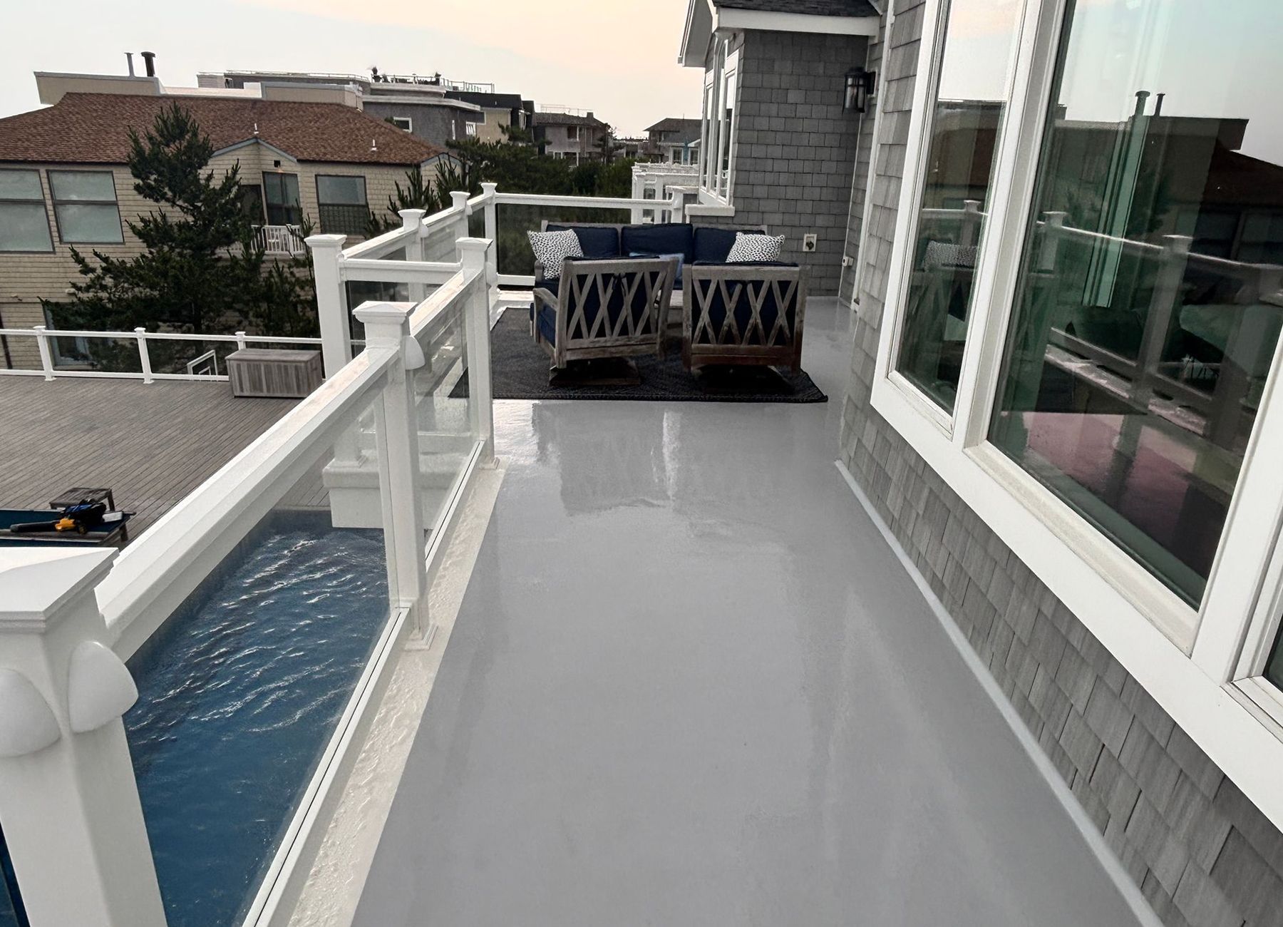 A balcony with a white railing and a couch on it