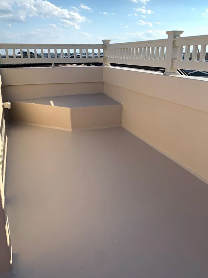 A balcony with a white railing and stairs