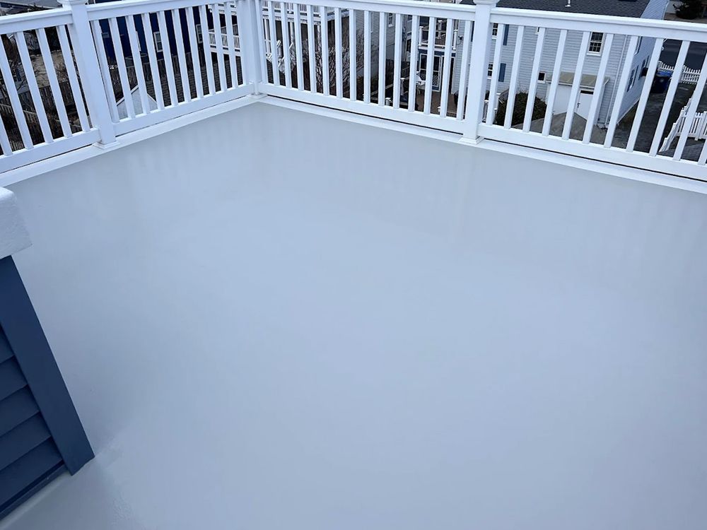 A balcony with a white railing and a white floor.