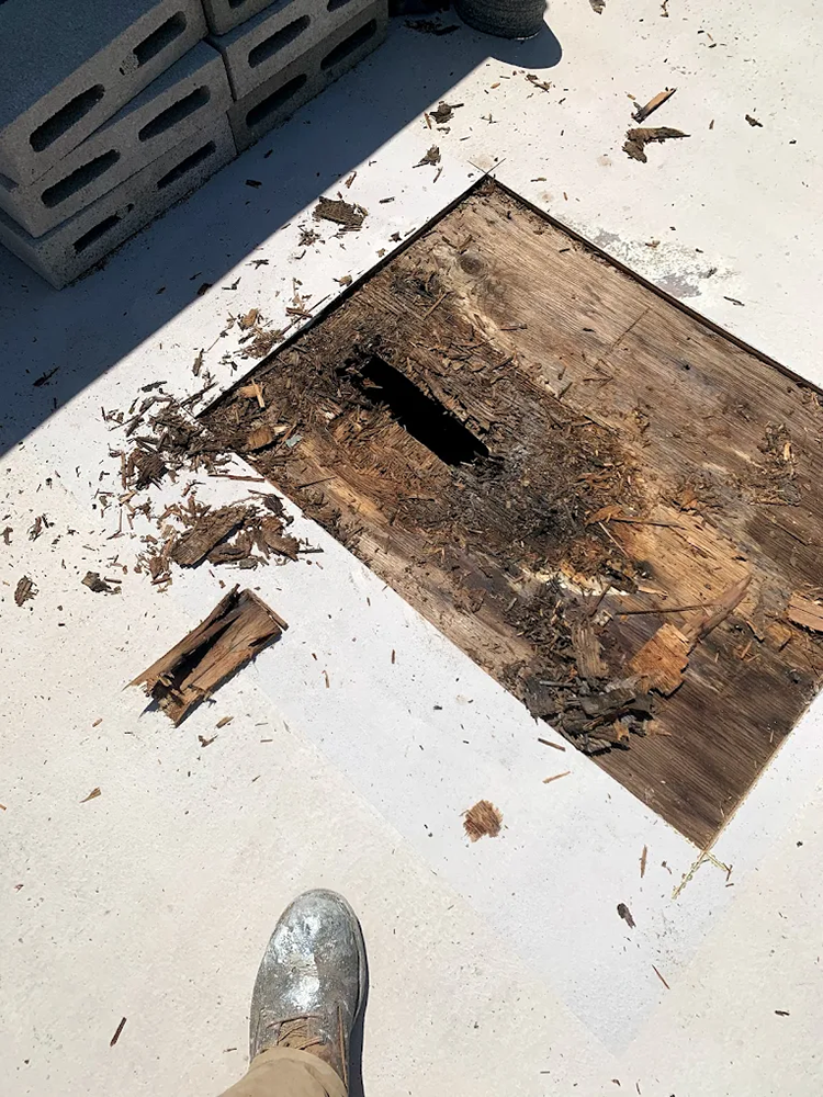 A person is standing in front of a hole in the ground