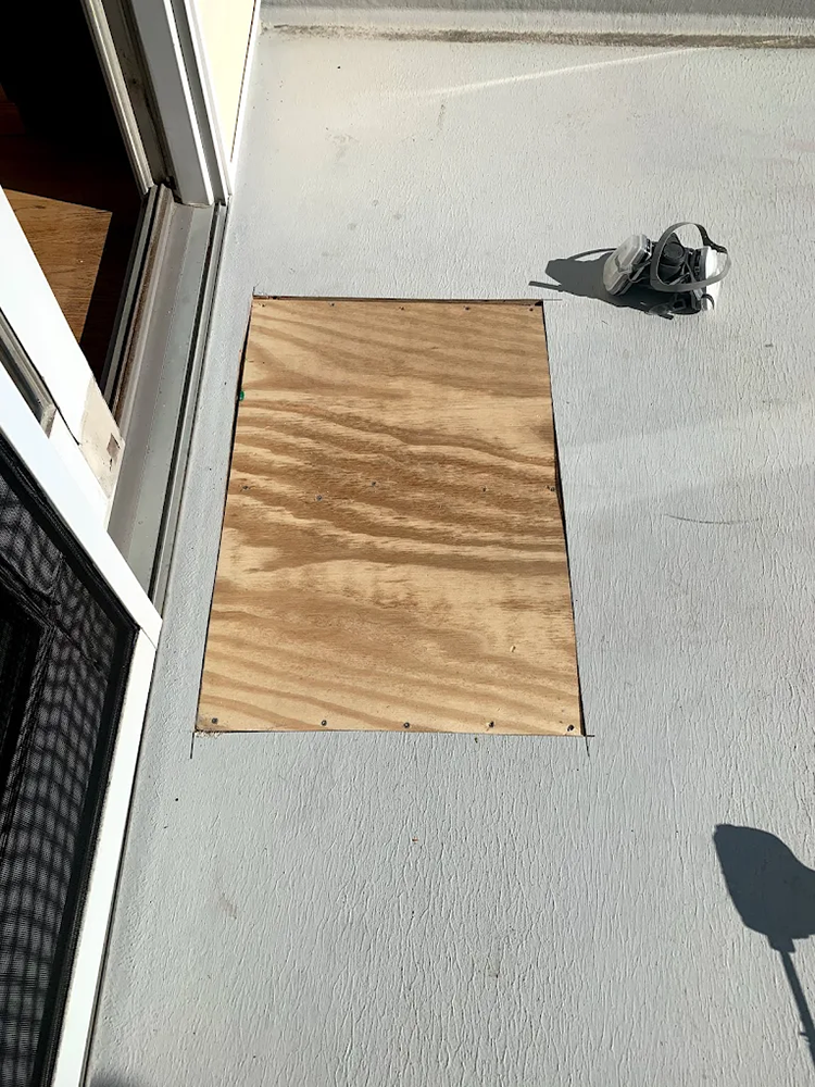 A piece of wood is sitting on top of a concrete floor.