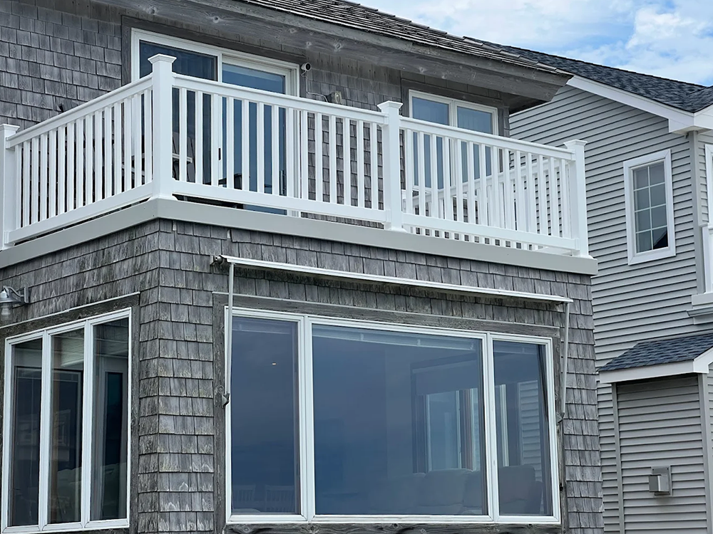 A house with a balcony and a lot of windows
