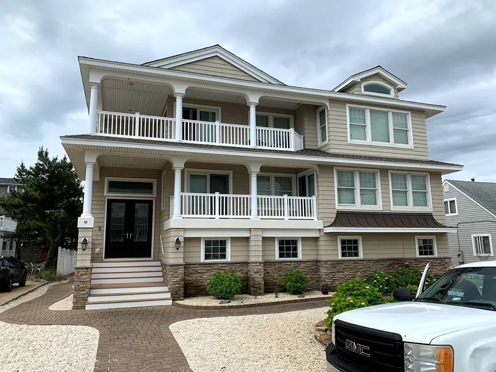 A large house with a white truck parked in front of it.