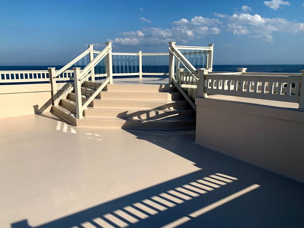 Stairs leading up to a balcony overlooking the ocean