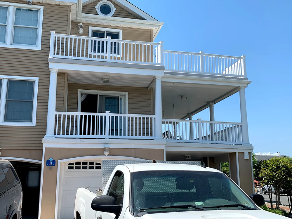 A white truck is parked in front of a house