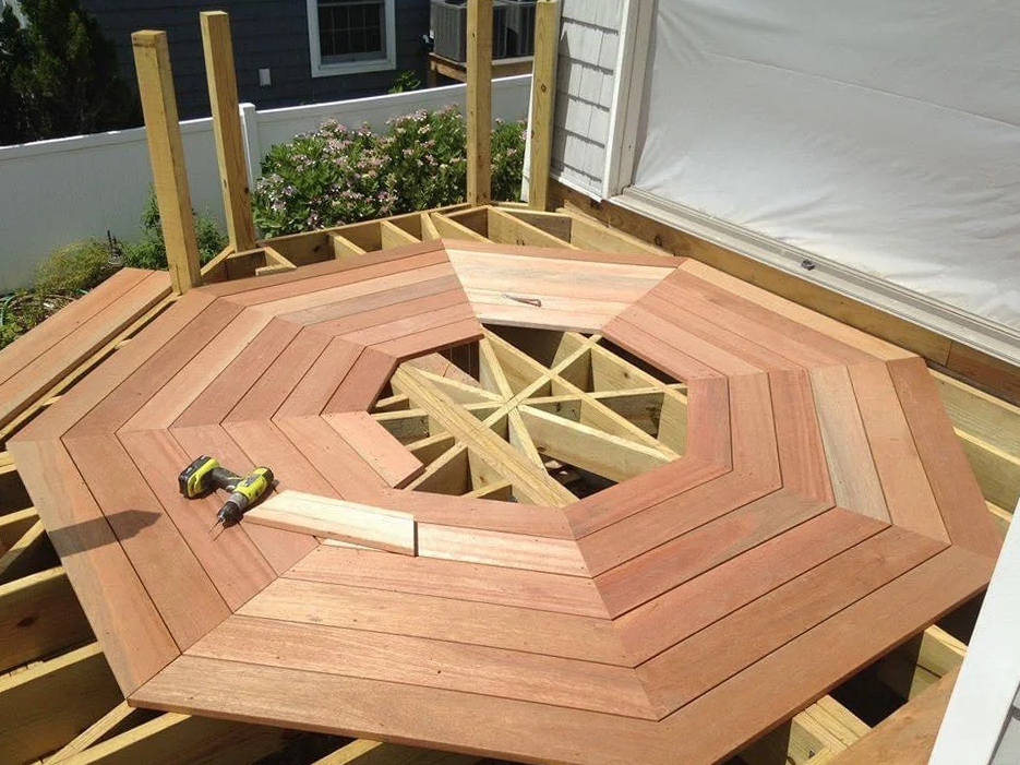 A wooden deck is being built with a drill on top of it.