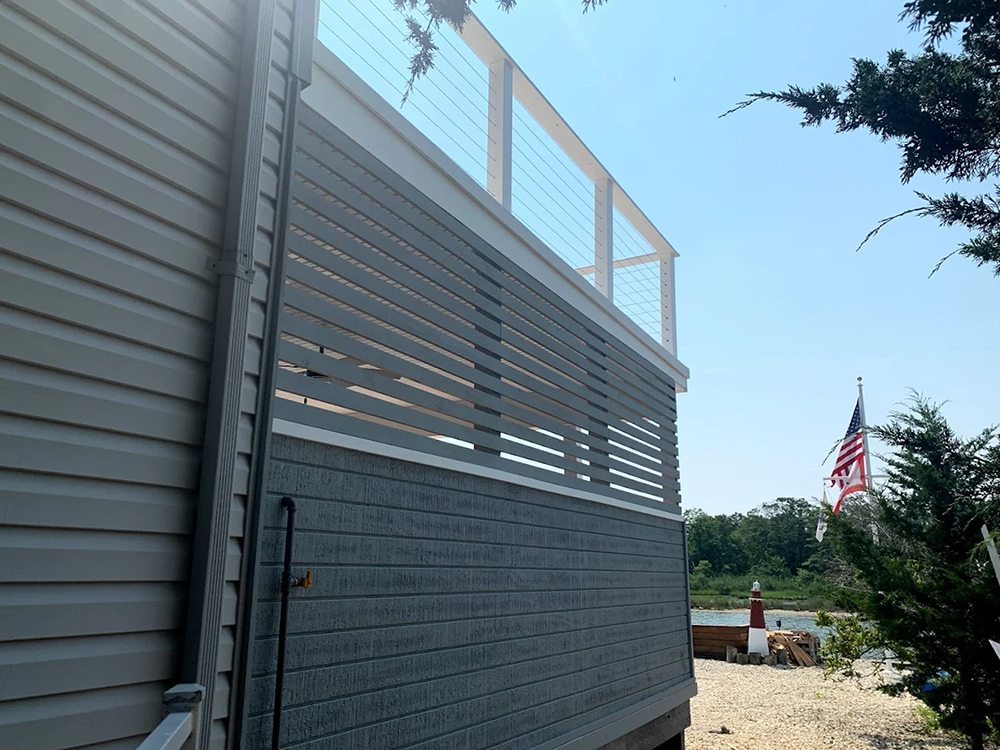 A house with a balcony and an american flag in the background