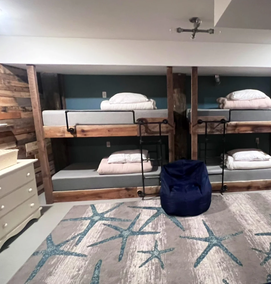 A room with bunk beds and a bean bag chair