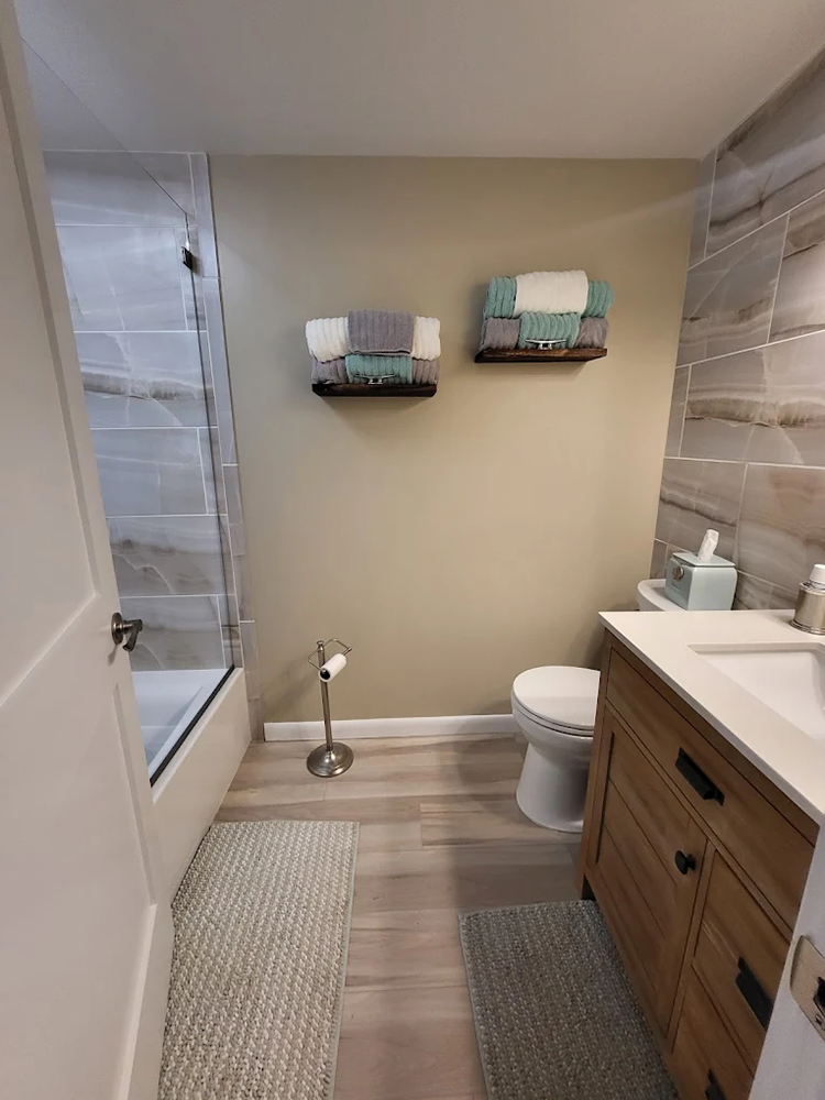 A bathroom with a toilet , sink , and bathtub.
