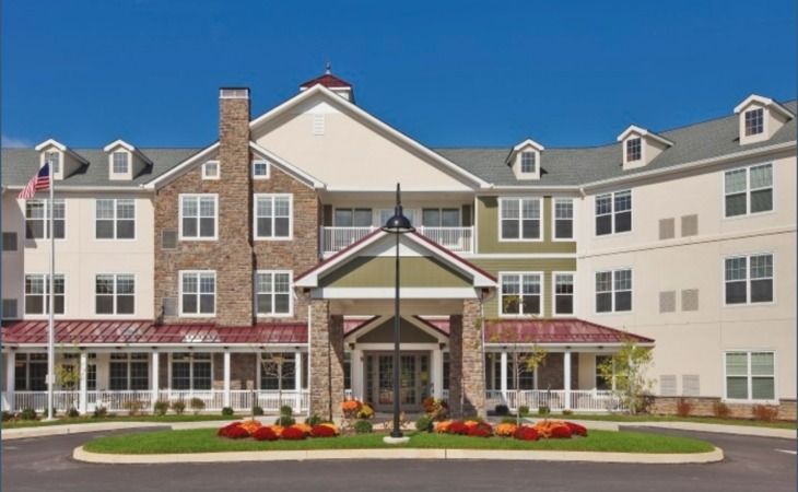 A large apartment building with a red roof