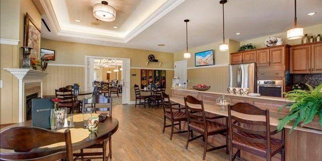 A large room with a table and chairs in it.