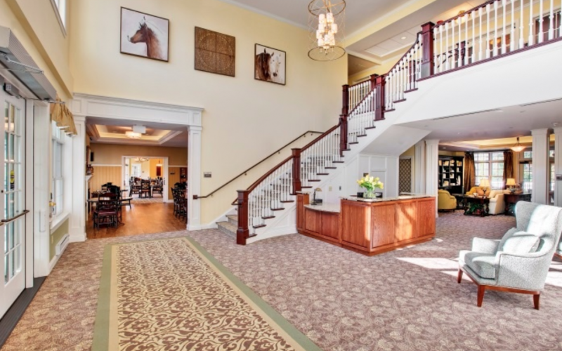 A large lobby with stairs and a reception desk