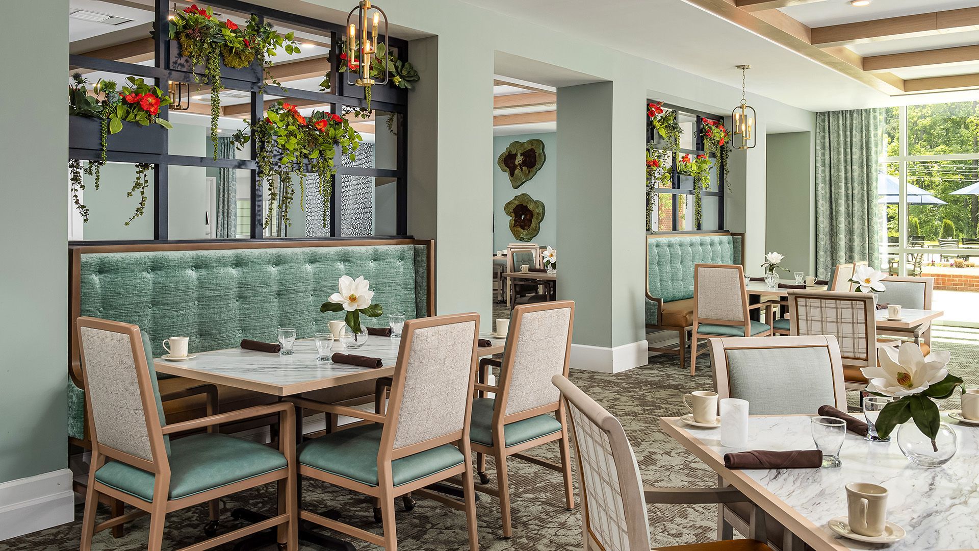A restaurant with tables and chairs in a large room.
