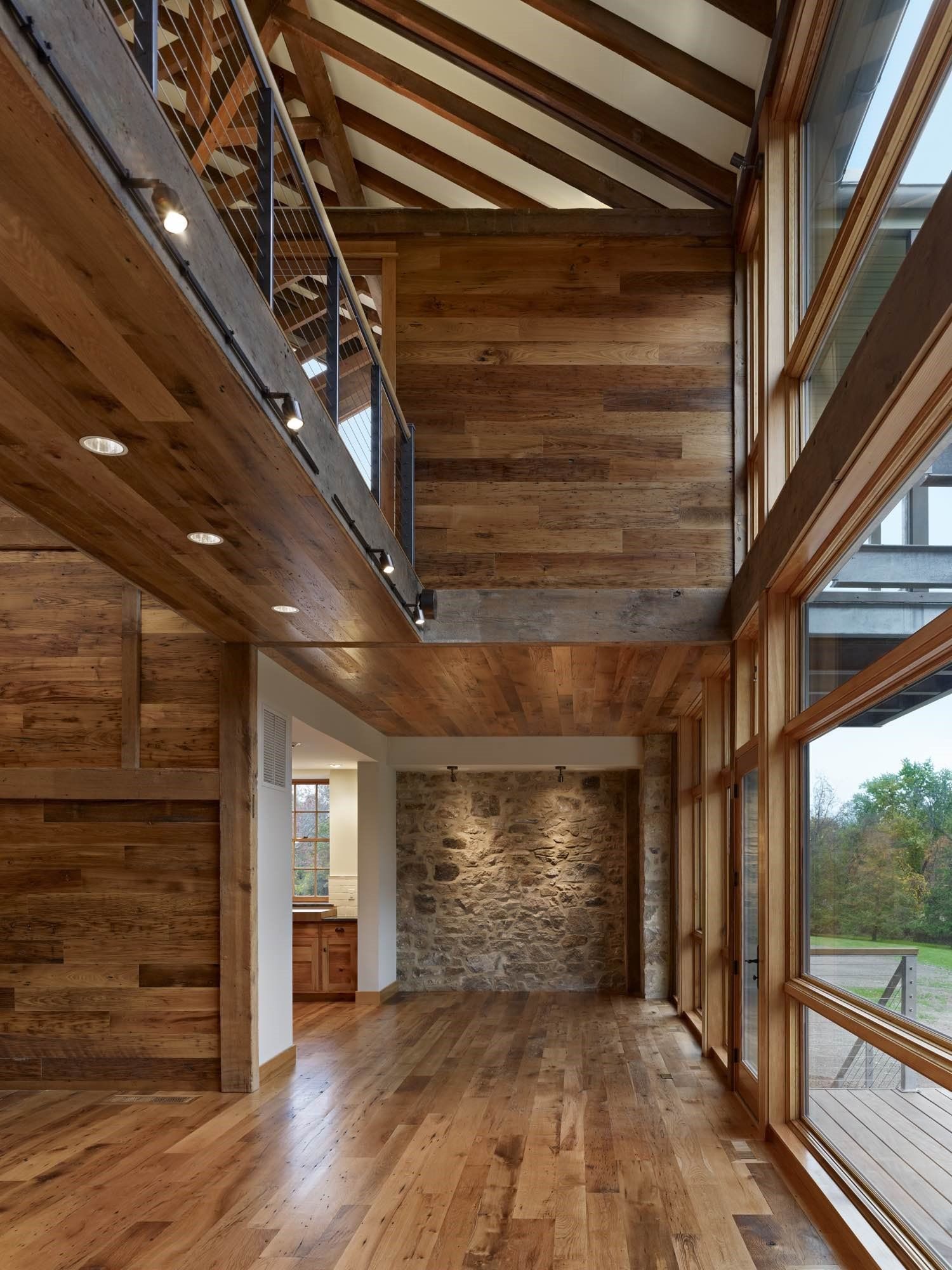 A large room with lots of windows and wooden walls