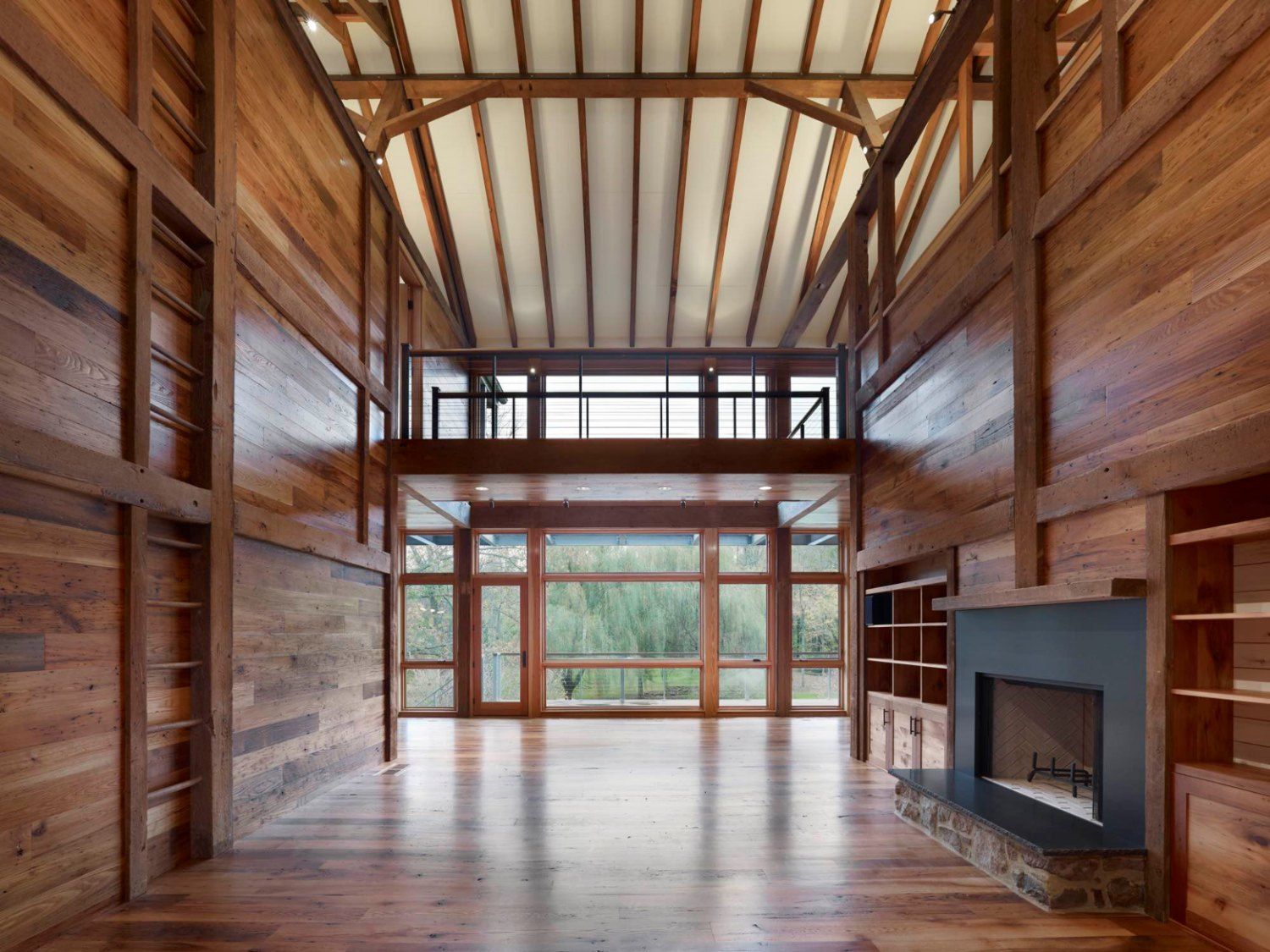 A large room with wooden walls and a fireplace