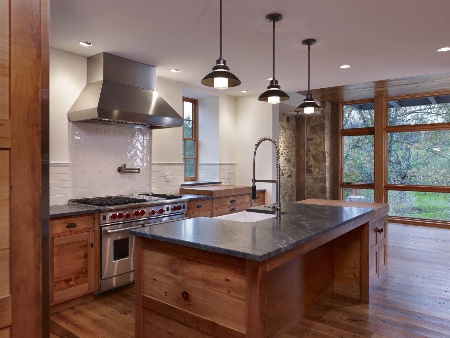 A kitchen with a large island and stainless steel appliances