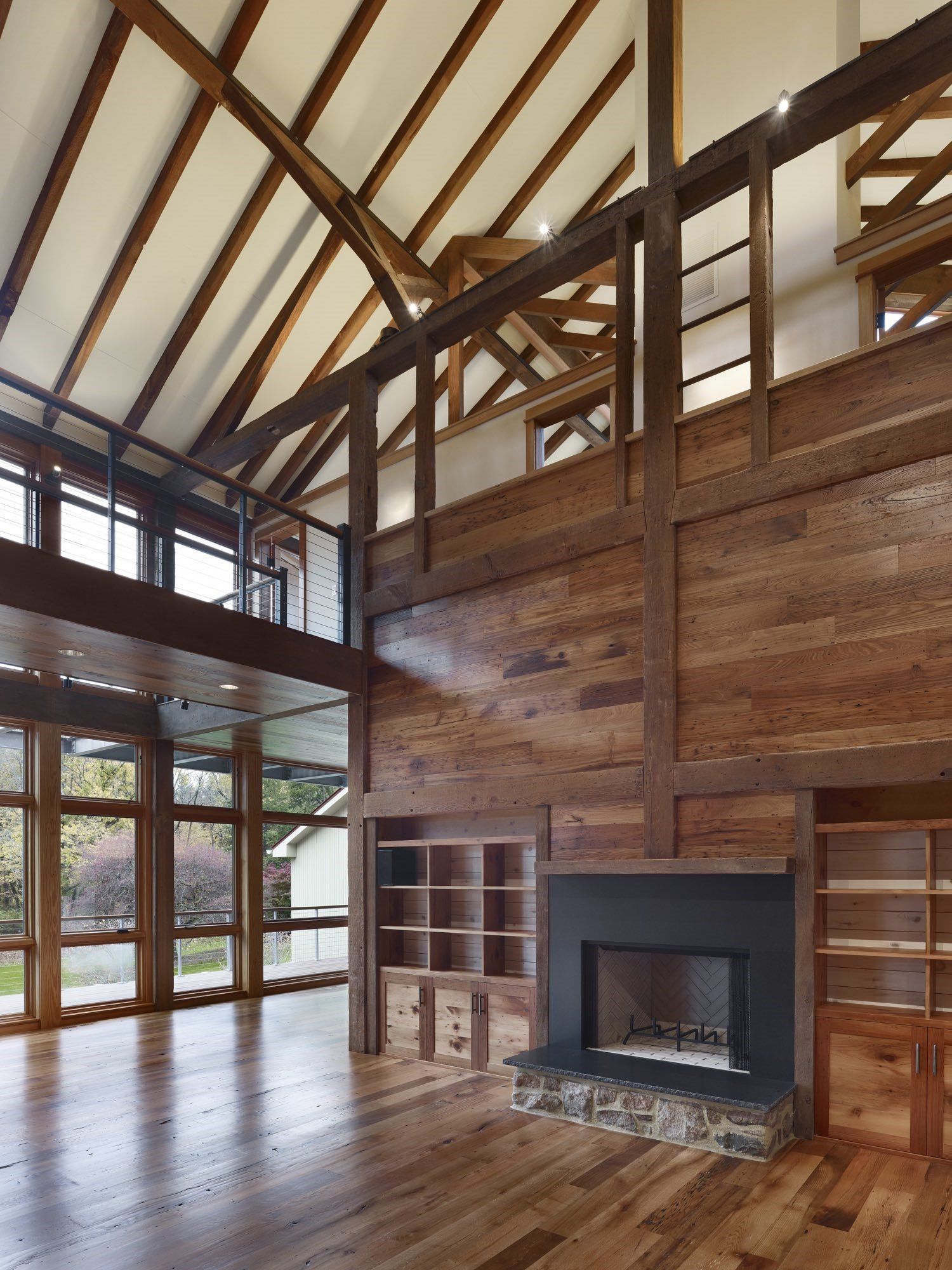 A living room with a fireplace and lots of windows