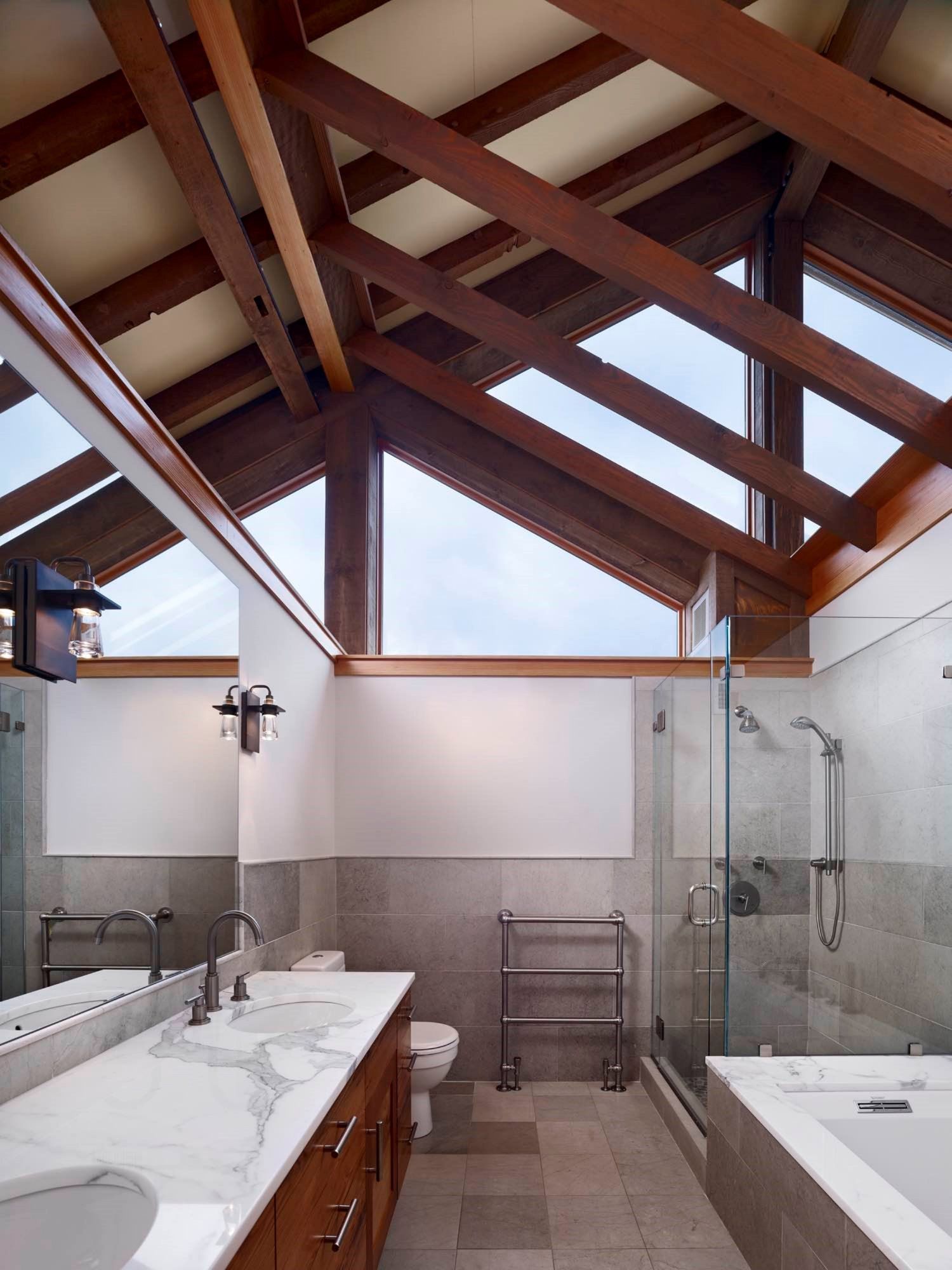 A bathroom with a vaulted ceiling and lots of windows