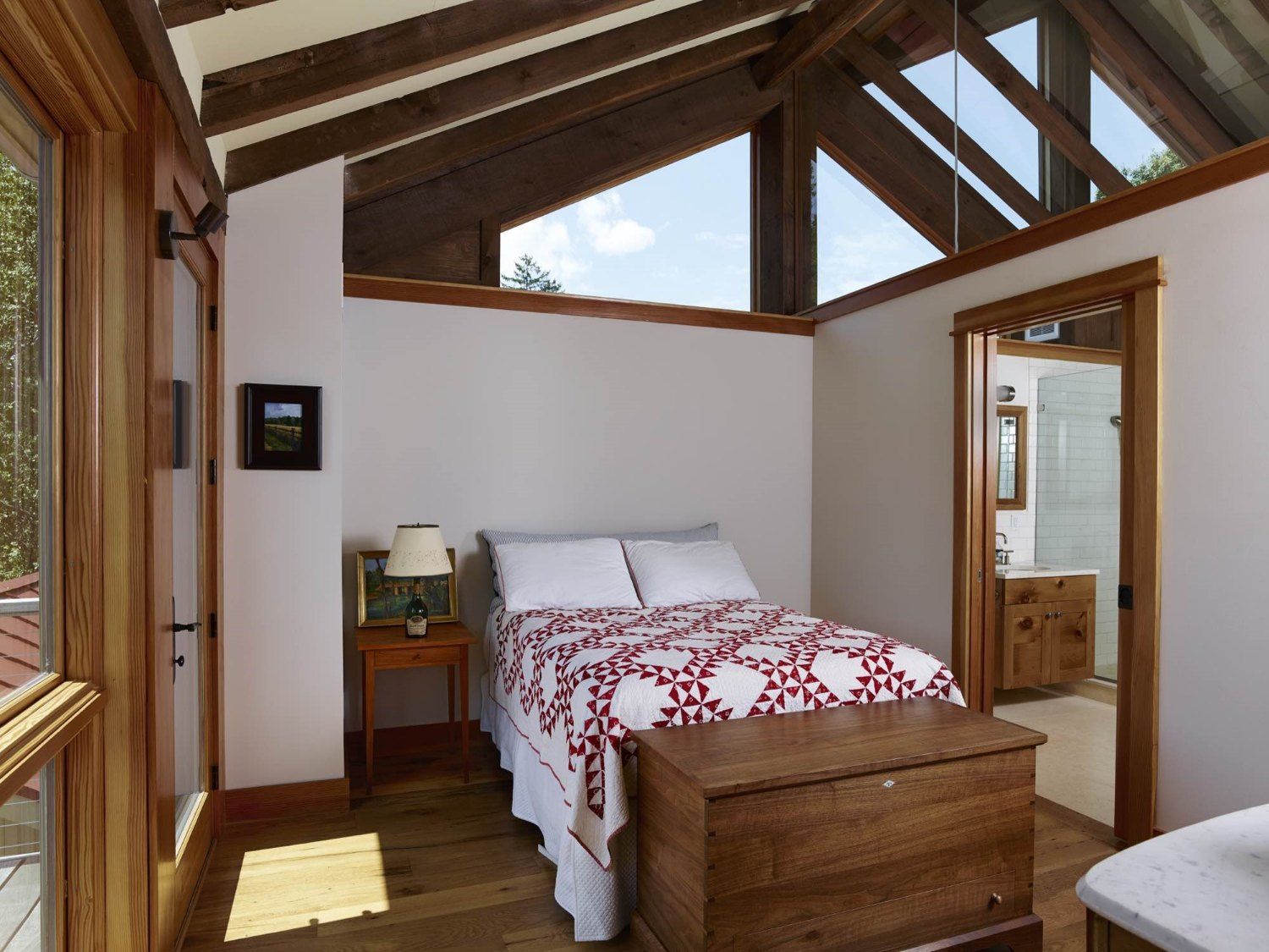 A bedroom with a bed and a trunk in it