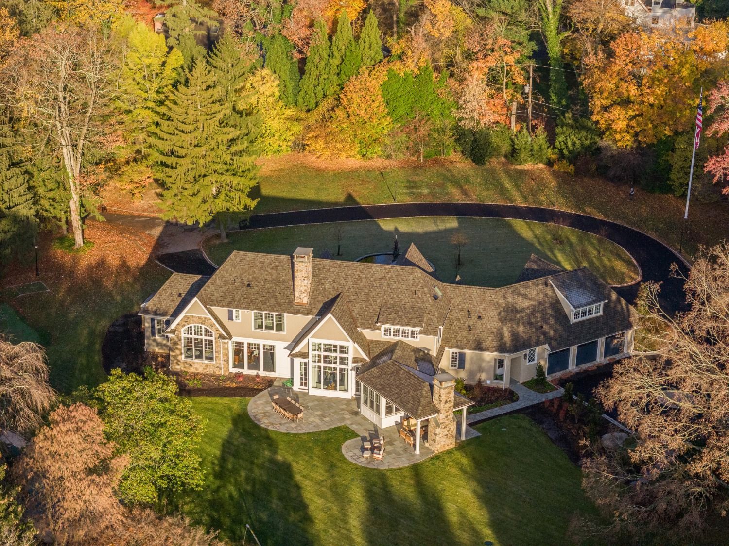 An aerial view of a large house surrounded by trees.