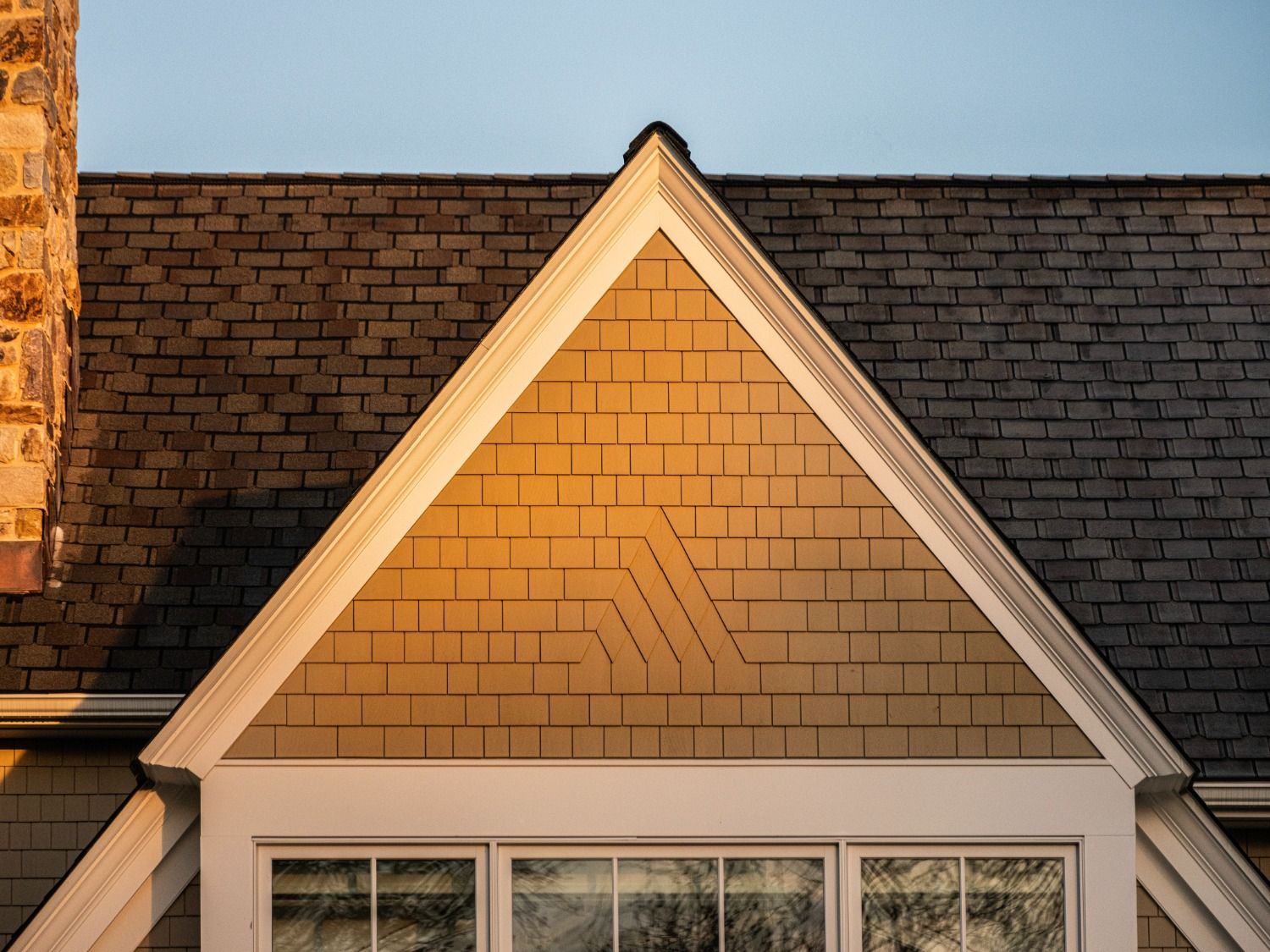 A house with a triangle shaped roof and a window