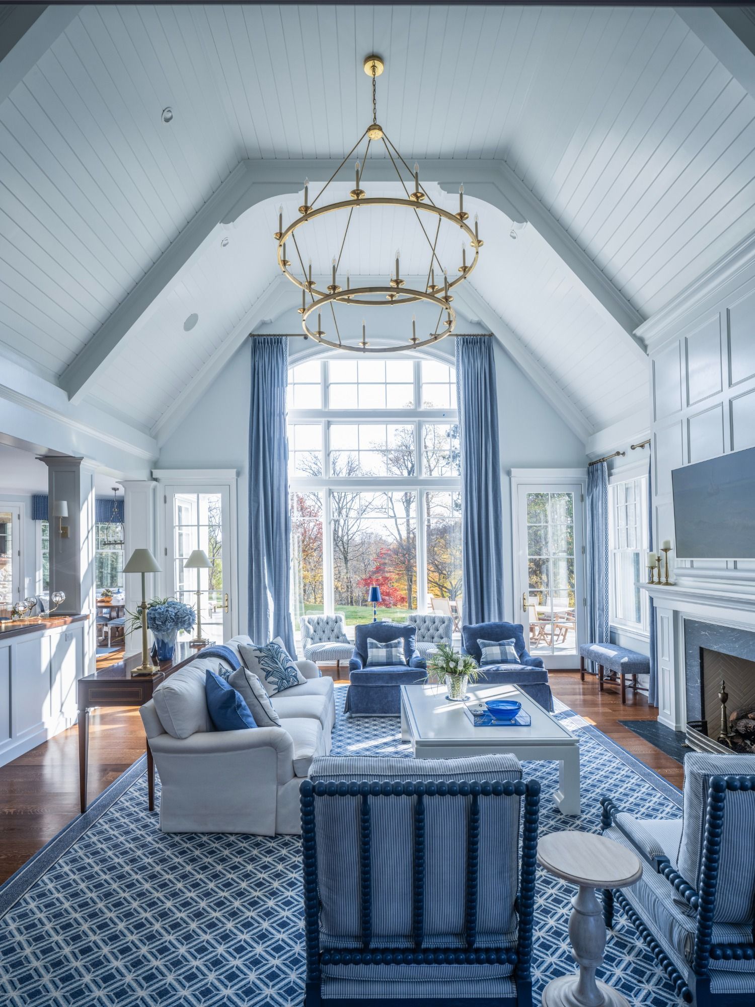 A living room with a vaulted ceiling and lots of furniture