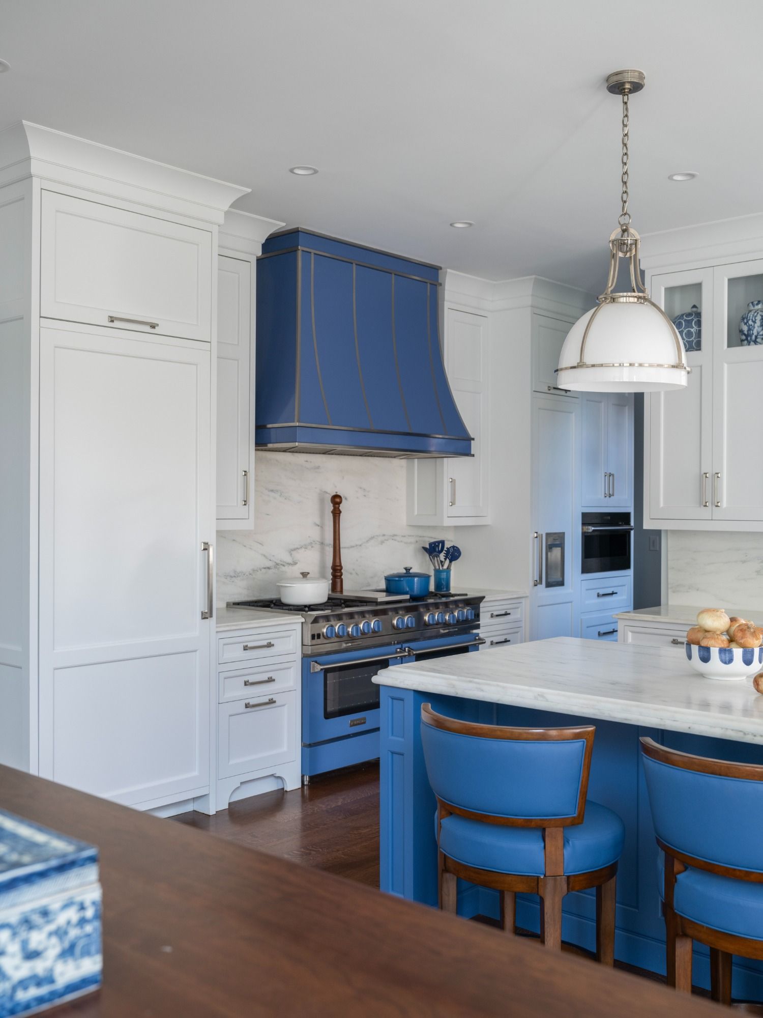 A kitchen with white cabinets and blue appliances