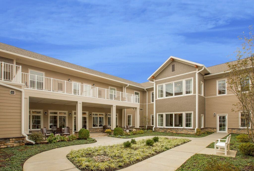 A large building with a lot of windows and a walkway leading to it.