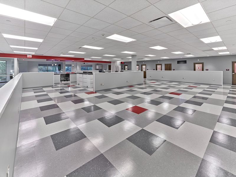 A large room with a checkered floor and white walls