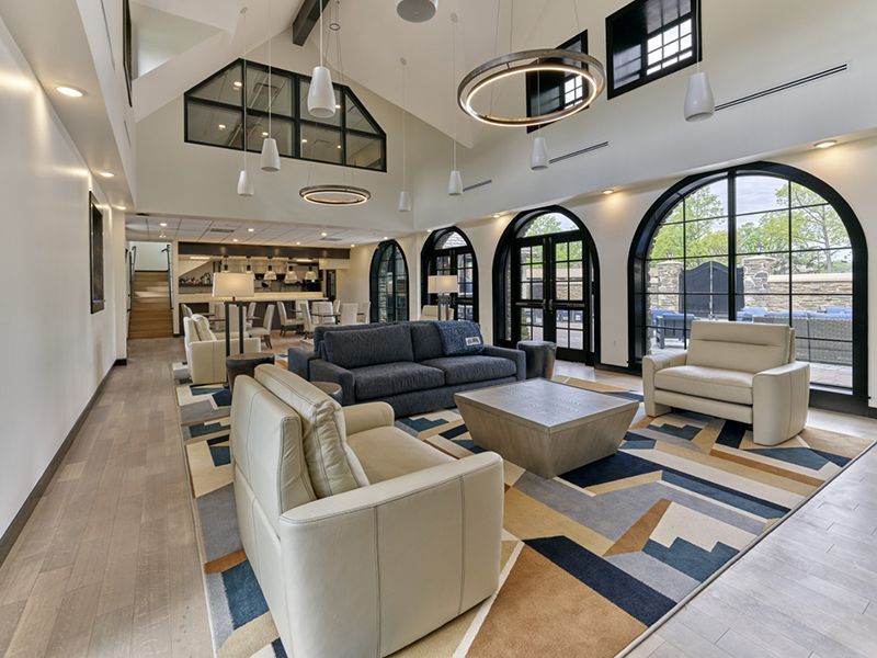 A living room with a couch , chairs , and a coffee table